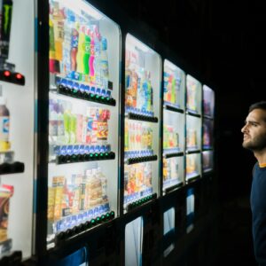 A person having descision fatigue in front of vending machines